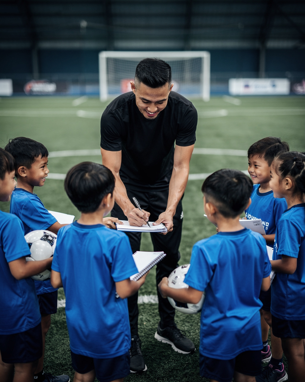 Signing autographs for academy kids