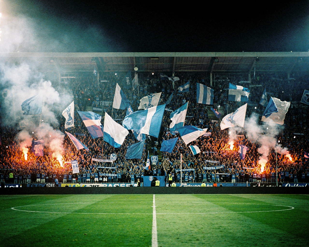 The away end waving cobalt flags and flares